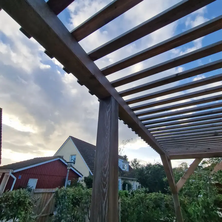 Färdig träpergola vid ett uteplatsprojekt utfört av 87 Bygg